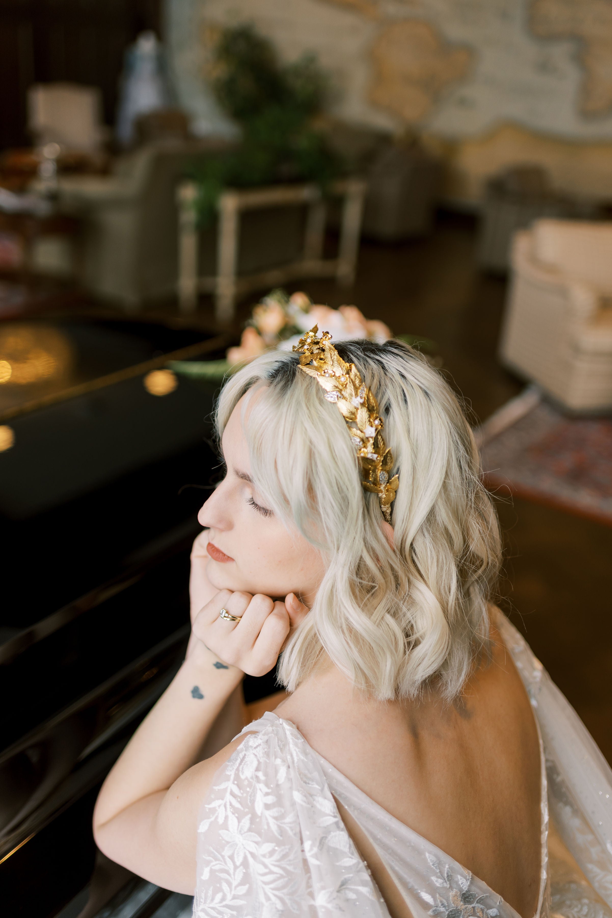 Woman with a gold headband in a room with furniture and decor