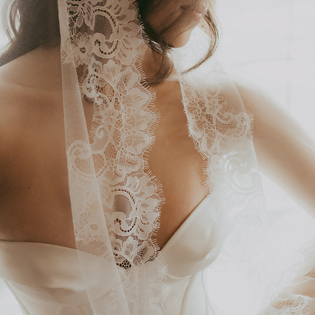 Lace-trimmed wedding dress with a soft focus background