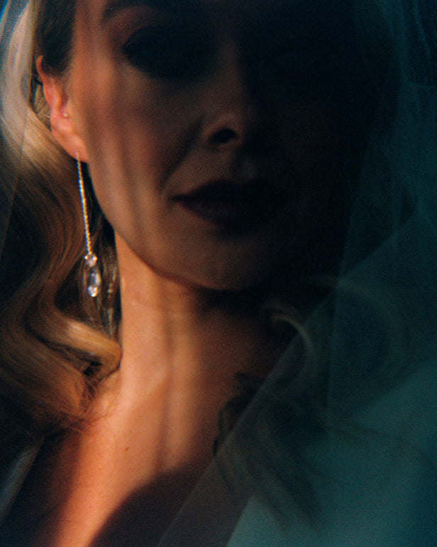 Close-up of a person wearing a light blue garment with a blurred background