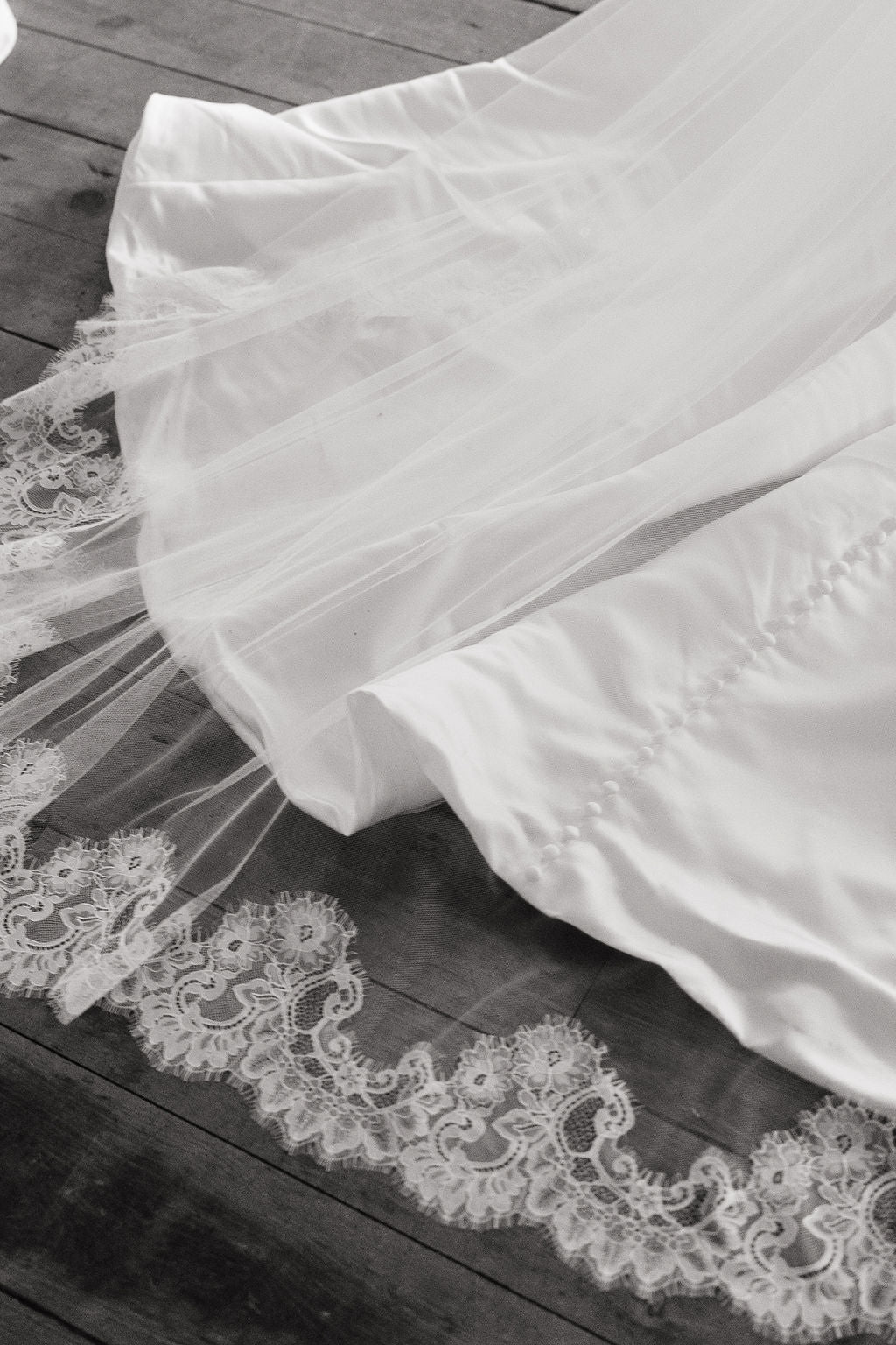 White lace wedding dress on a wooden floor