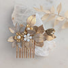 Decorative hair comb with floral and leaf details on a light background