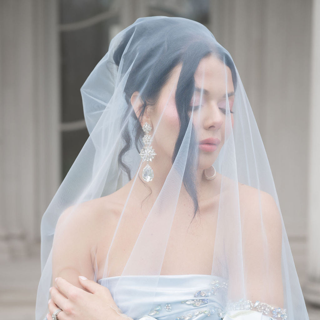 Woman wearing a floral dress and veil with a blurred background