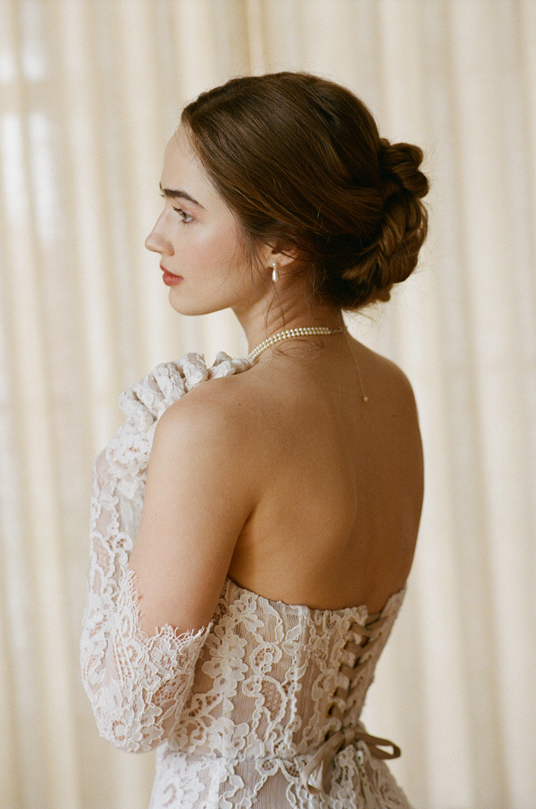 Woman in a lace dress with a neutral background
