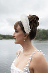 Woman wearing a white headband and pearl dress in Muskoka Canada