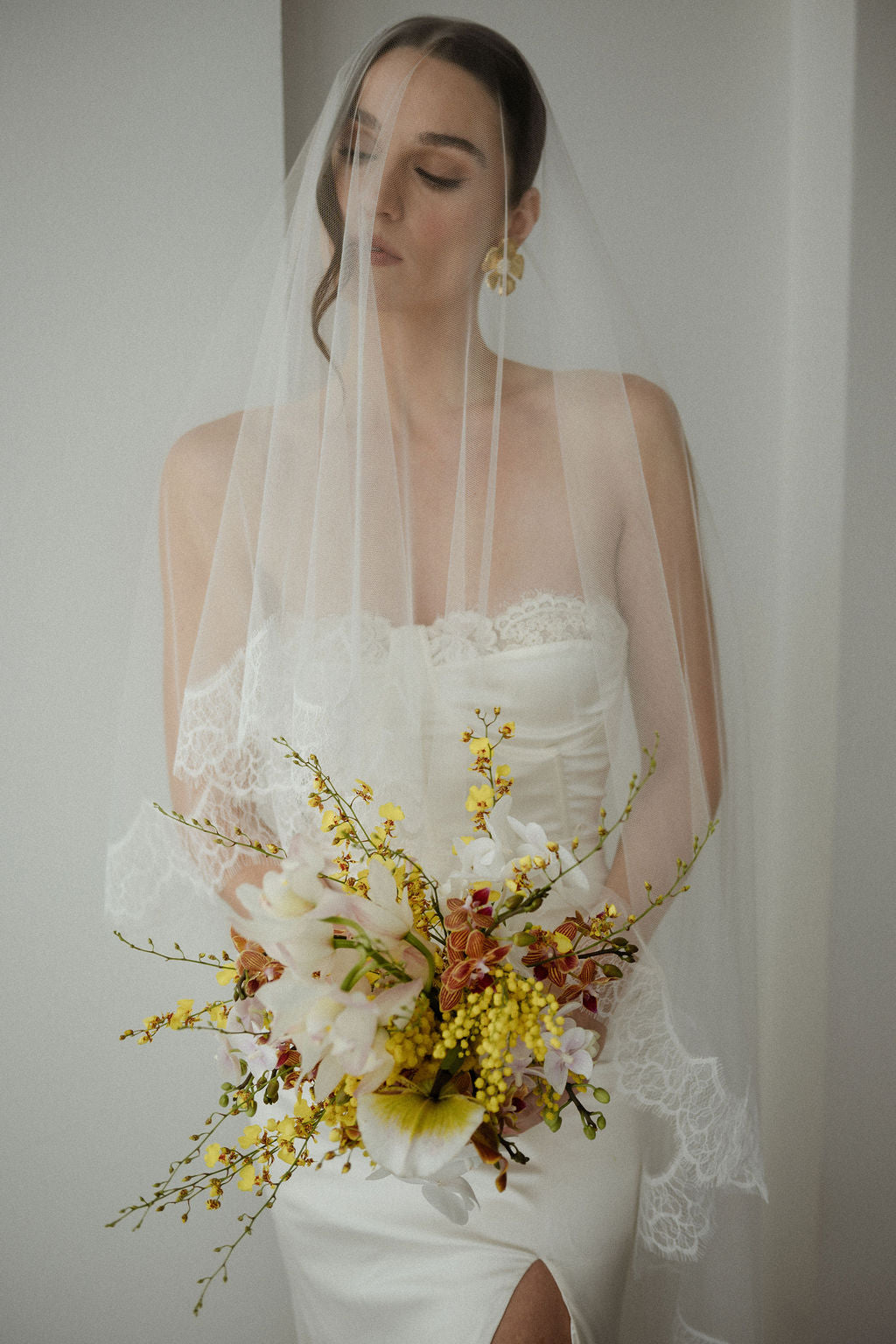 Bride holding a bouquet with a plain background