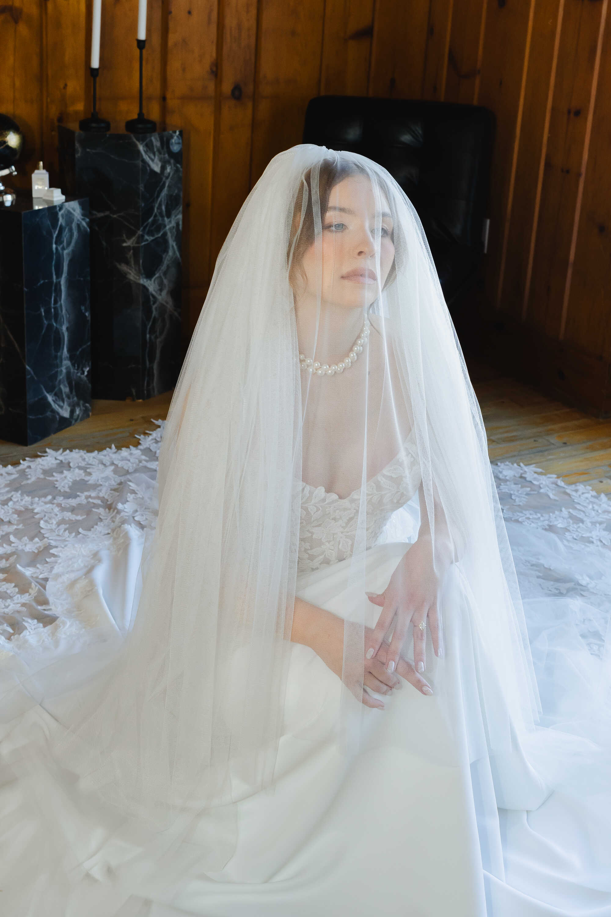 Woman in a wedding dress with a veil indoors.