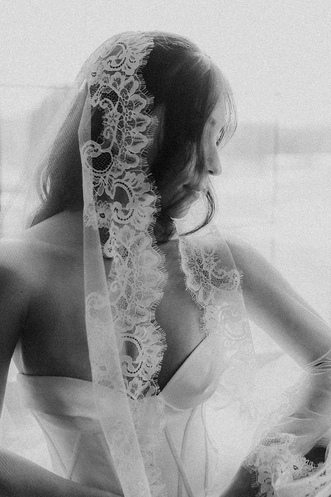 Black and white photo of a woman wearing a lace veil