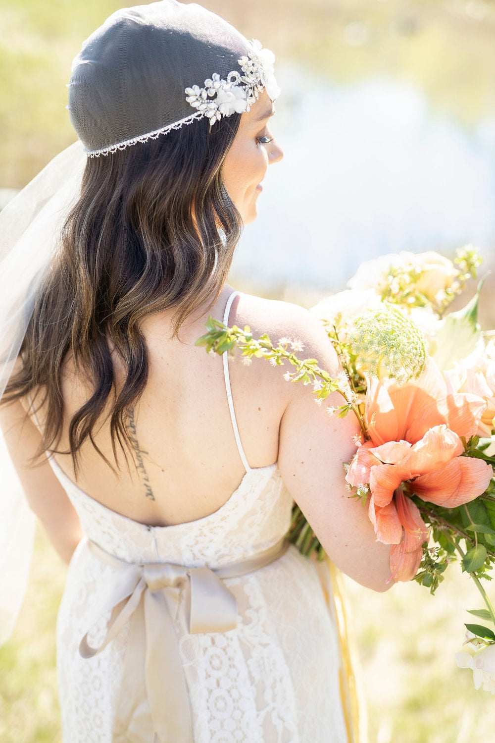Vintage Inspired Crystal Juliet Cap Veil embellished with rhinestones, crystals, pearls and handmade silk organza flowers. Fitted cap with a long fingertip length side veil. handmade in toronto by Blair Nadeau Bridal