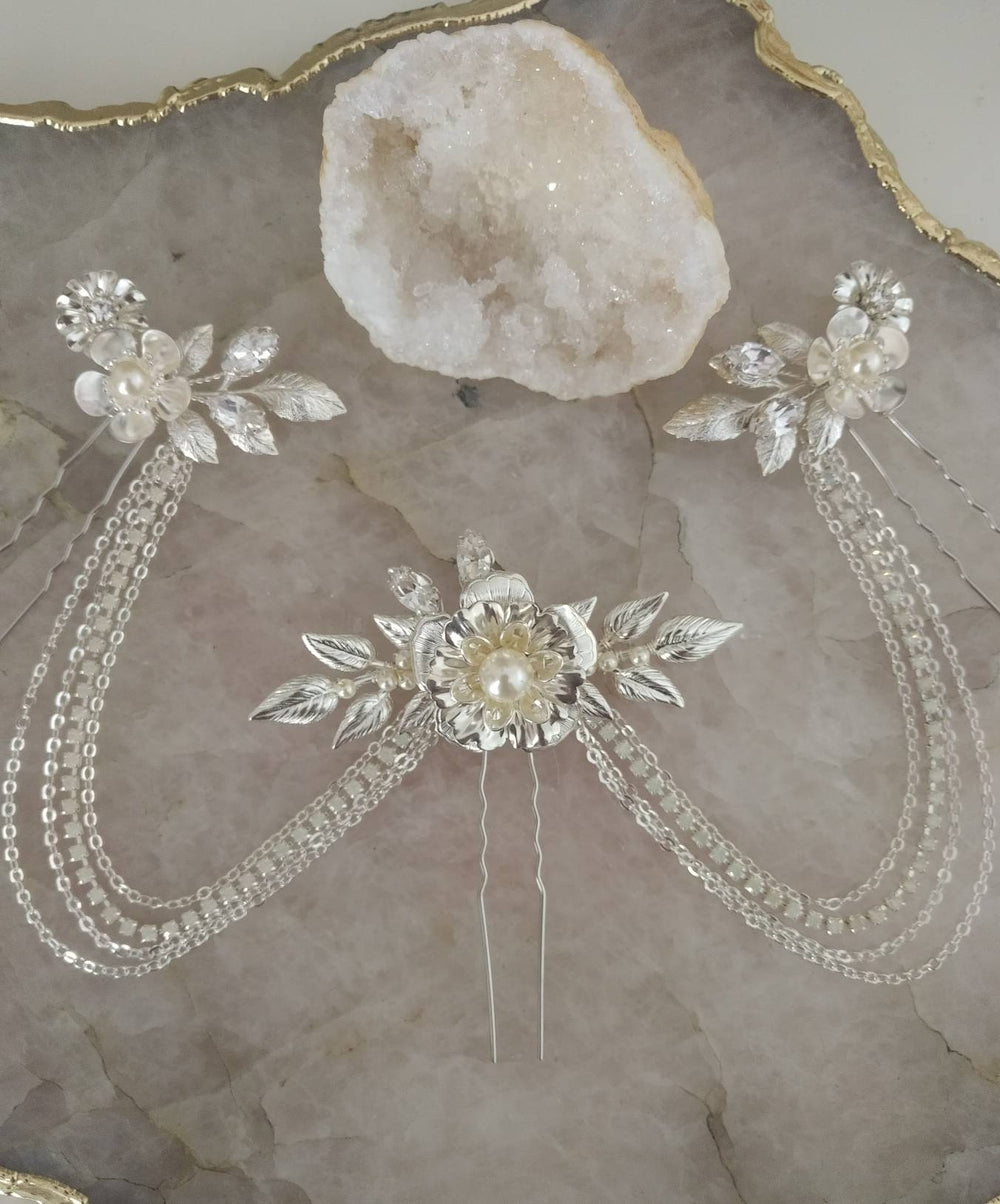 silver flower and leaf hair chain accented with crystals and pearls. handmade in canada by blair nadeau bridal
