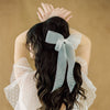 ivory double layer organza bridal hair bow with scattered pearls on the ribbon tails. handmade in canada