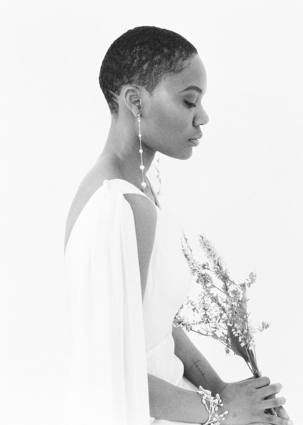 black and white photo of dramatic long pearl chain earrings for brides