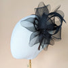 black bridal fascinator with large crin loops and silk ribbons. Accented with feathers and crystals. Handmade in toronto by blair nadeau bridal