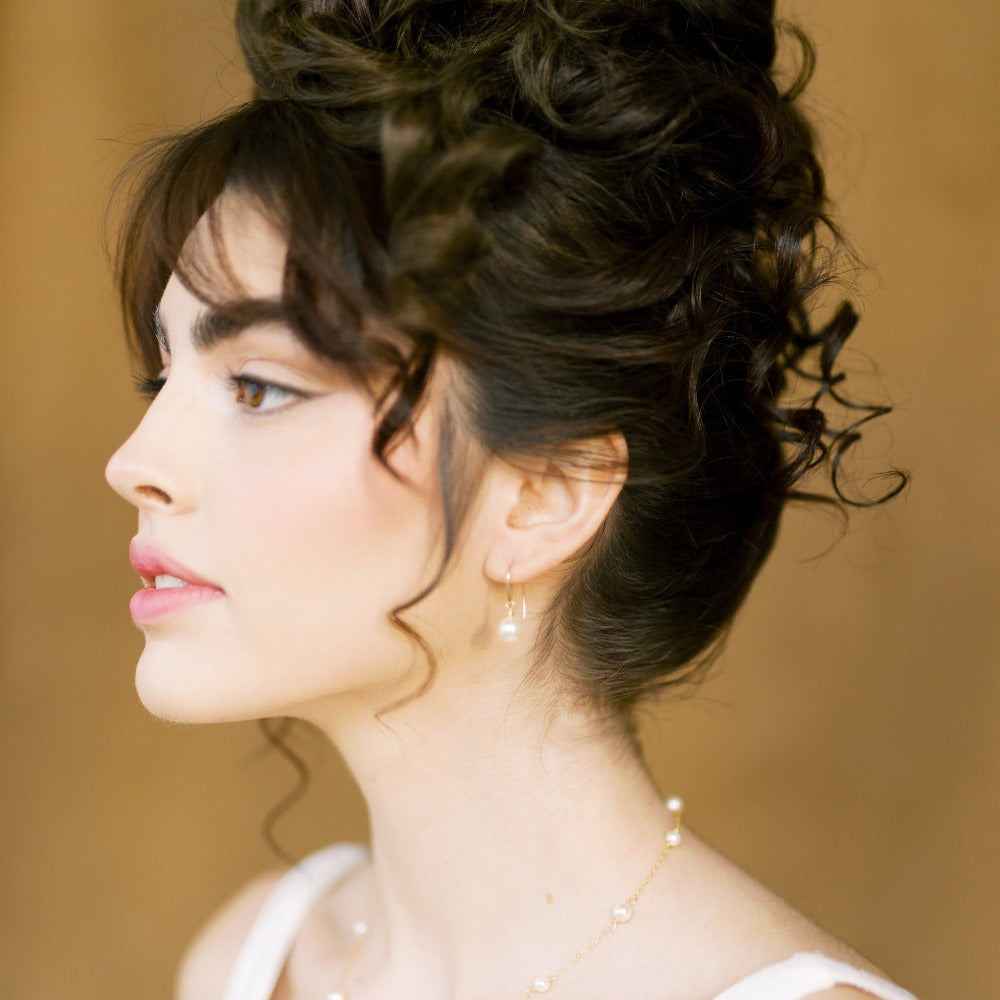 dainty 8mm round glass pearl drop earrings with a sterling silver or filled ear wire.  Perfect for the classic modern bridal. Available in silver, gold and rose gold finishes and in white, ivory, blush or iridescent pearls. handmade in toronto canada by blair nadeau bridal adornments