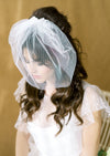 chin length birdcage veil with bow on comb