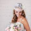 beautiful elbow length full cap handbeaded lace trim juliet cap veil with large handmade organza flower and velvet leaves.  made in toronto canada by Blair nadeau bridal adornments