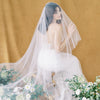 long off white romantic bridal drop veil with lightly gathered comb.  Cut raw edge oval cut bridal veil available in multiple lengths and in pure white, off white and pale ivory. Handmade in Toronto Canada by Blair Nadeau Bridal Adornments
