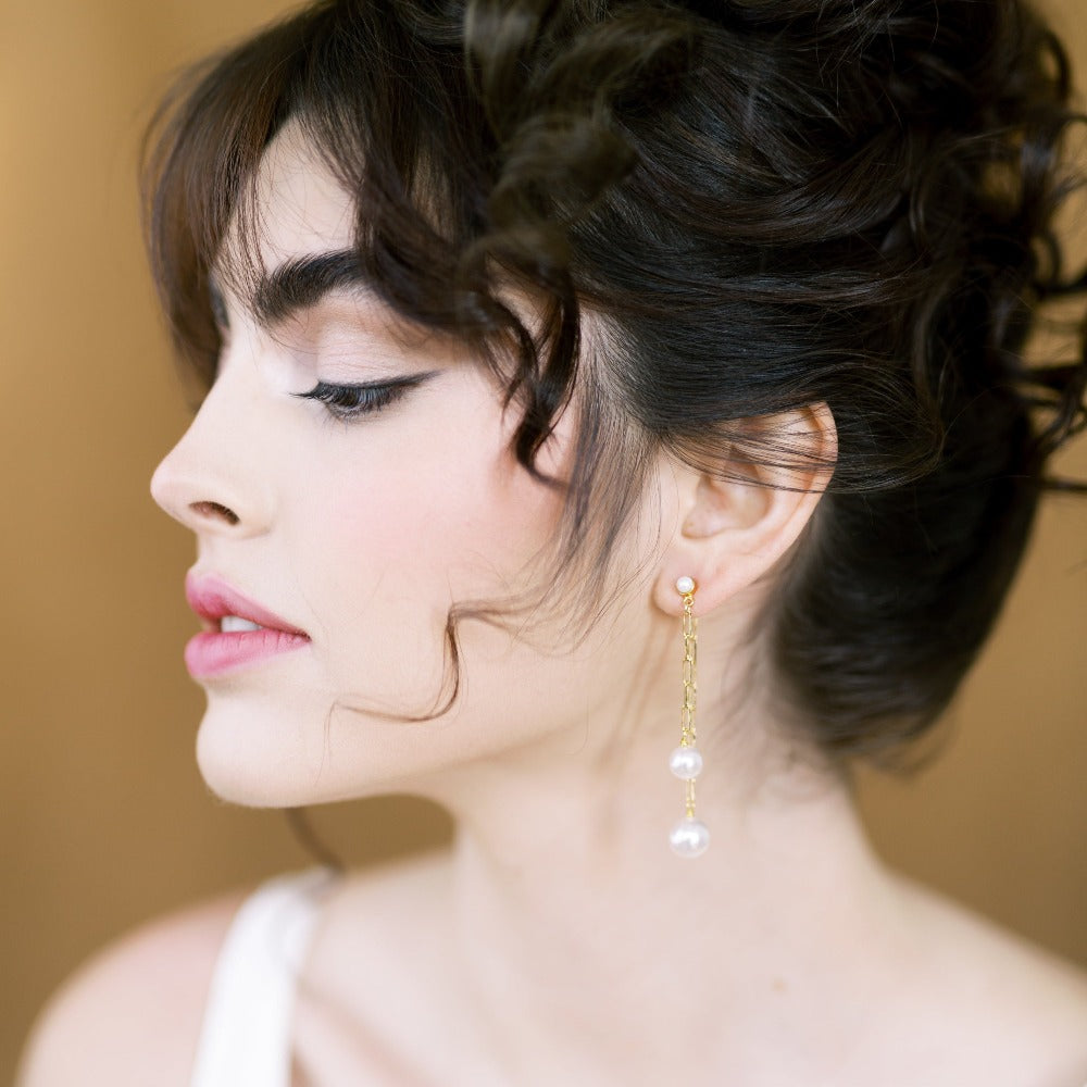 long paper clip chain style earrings with pearl drops. Ear huggy style with a pearl earring post. One chain is shorter in front with an 8mm pearl and the back chain attached to the backing is longer with a 10mm pearl.  Silver gold or rose gold metal. handmade in toronto canada by blair nadeau bridal adornments