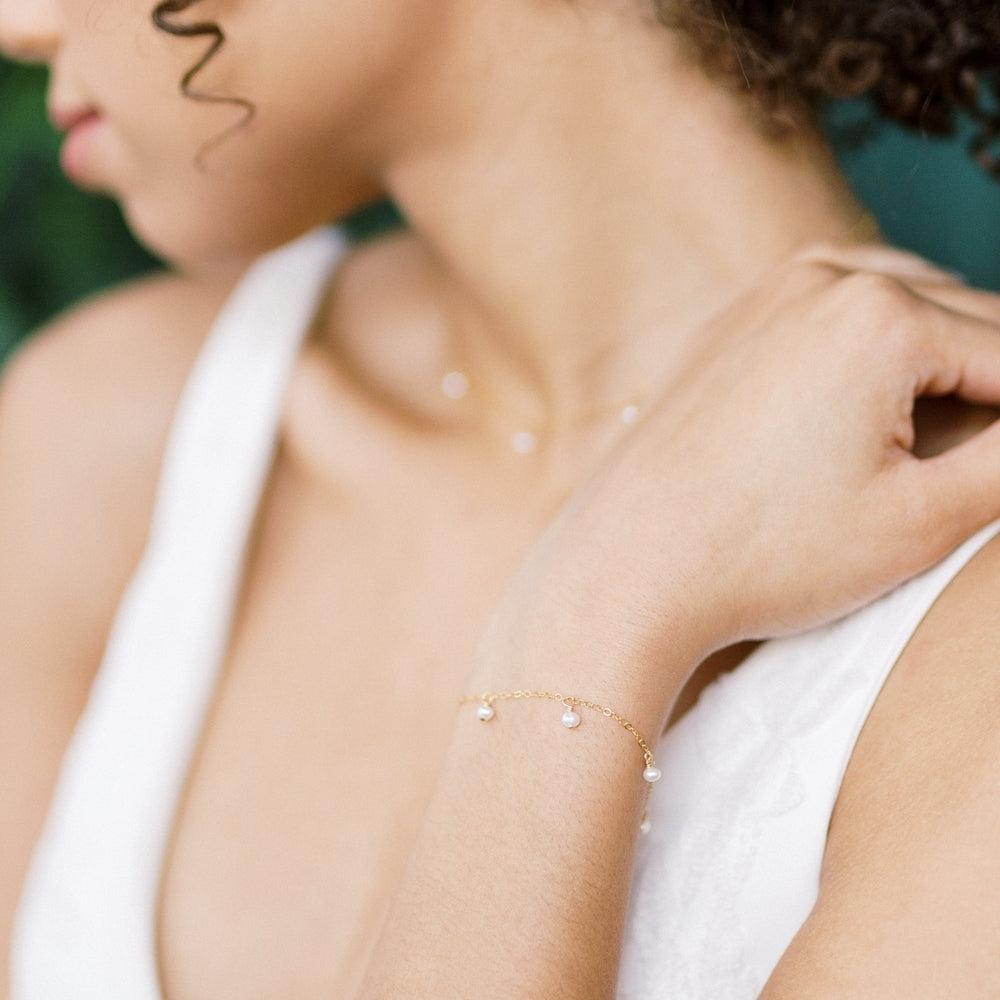 Delicate chain bracelet with the tiny freshwater pearl dangle drops hand linked to the chain. Available in sterling silver, rose gold filled and gold filled with an extender chain for extra length. Handmade in Toronto Canada, Blair Nadeau Bridal