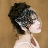 bandeau style birdcage veil with handbeaded pearls at the sides of veil