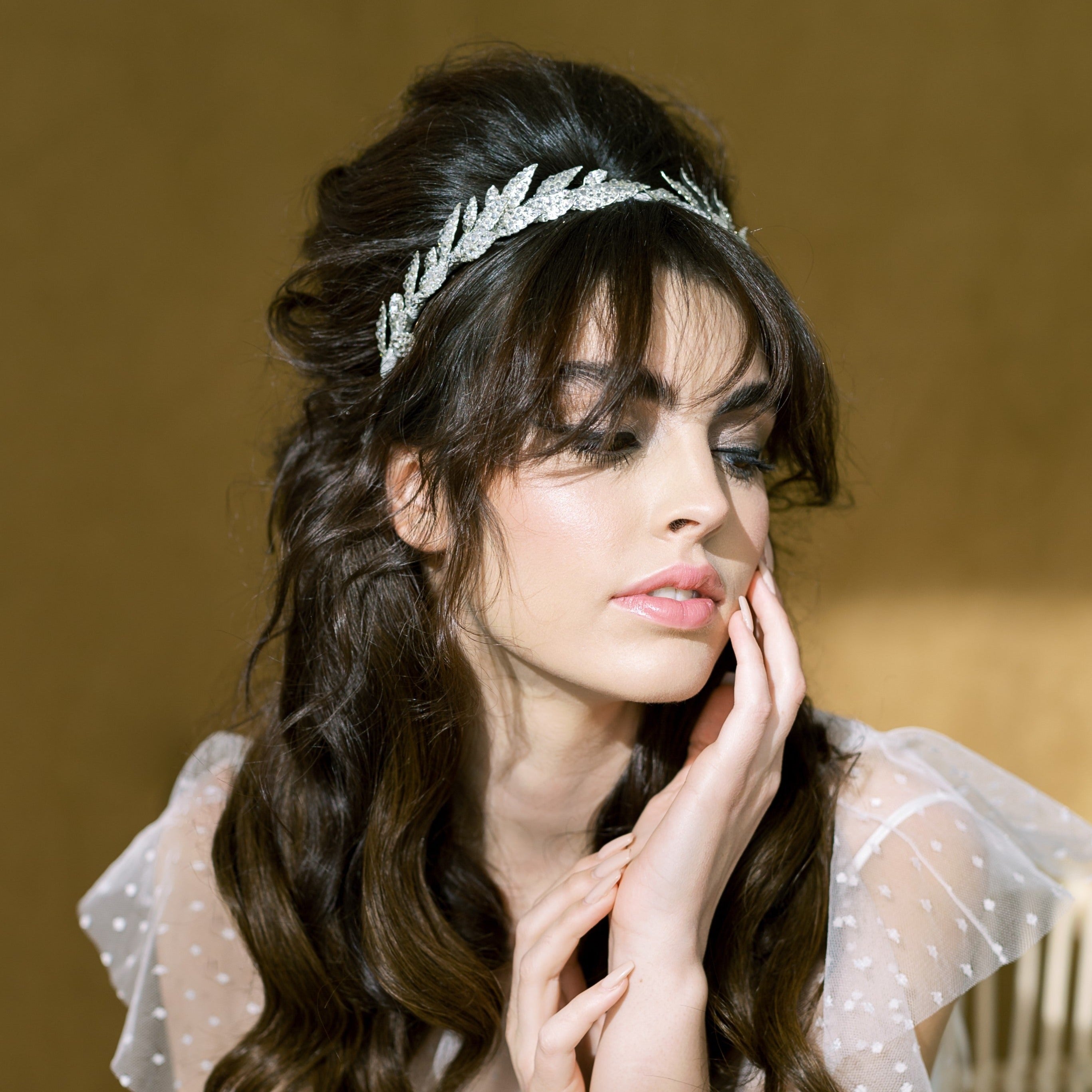 hand crafted metal leaf crown completely encrusted with crystal rhinestones on the leaves in various sizes with sprigs of navette rhinestones.. each leaf is handwired to a metal headband and ribbon wrapped with ribbon. Available in silver or gold. Handmade in Toronto Canada by Blair Nadeau Bridal Adornments