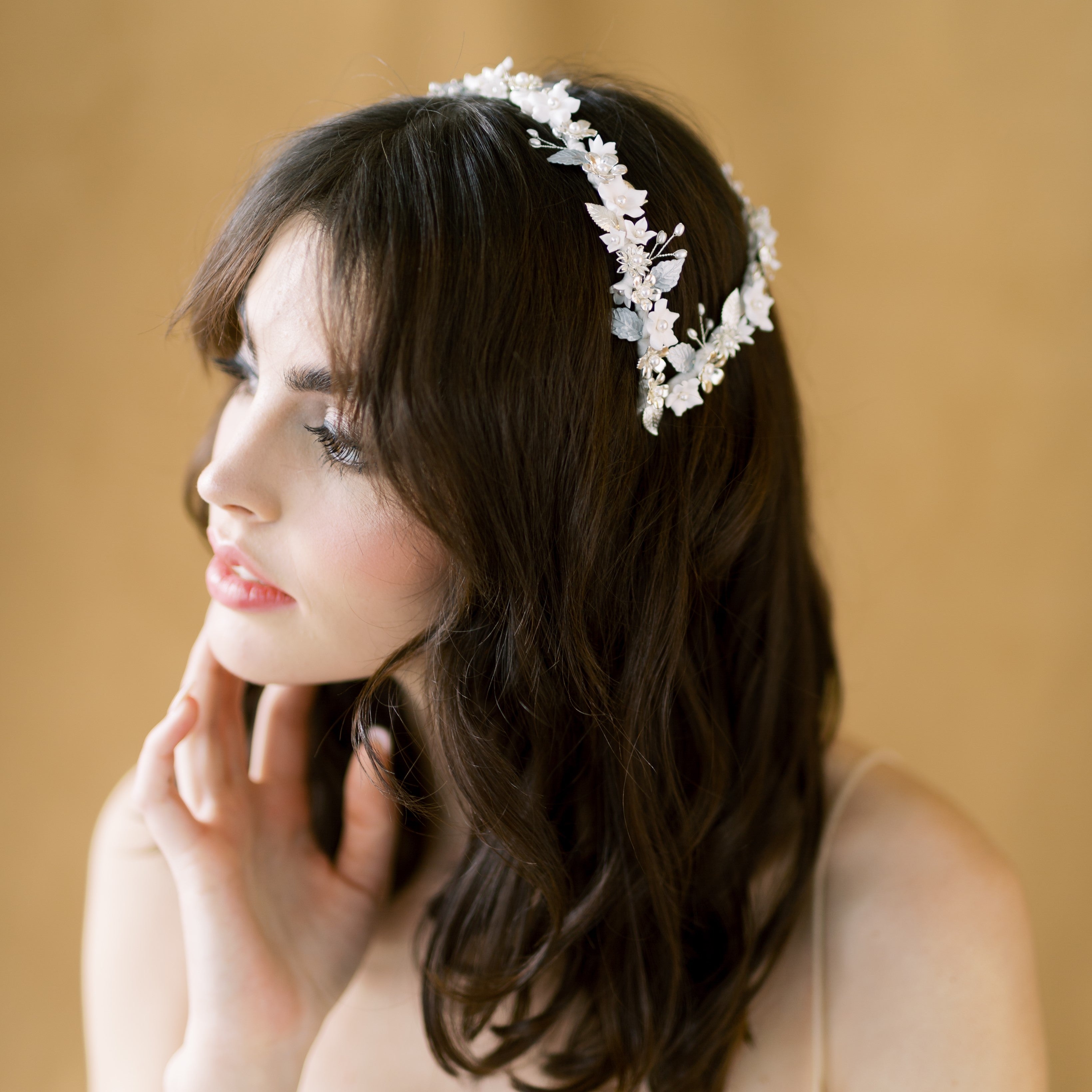 hand wired double headband crown with clay flowers, metal flowers and hand painted enamel leaves.  Ribbon wrapped with silk like ribbon for a flawless finish. Available in silver, gold or rose gold and white or ivory flowers. Made in Canada by blair nadeau bridal adornments