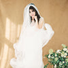 ultra sheer & super soft whisper tulle full volume veil. hand cut with raw edges and shaped into a beautiful oval hem.  Hand gathered onto a wide metal wire come for a beautiful waterfall shape. Available in pure white, off white & ivory - handmade in toronto ontario canada by blair nadeau bridal adornments