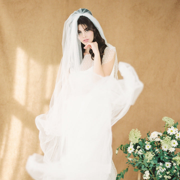 ultra sheer & super soft whisper tulle full volume veil. hand cut with raw edges and shaped into a beautiful oval hem.  Hand gathered onto a wide metal wire come for a beautiful waterfall shape. Available in pure white, off white & ivory - handmade in toronto ontario canada by blair nadeau bridal adornments