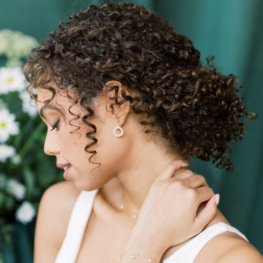 tiny organic freshwater pearl in a hoop shape hand linked to small round 4mm stud. available in sterling silver, rose gold filled and gold filled with off white ivory pearls. handmade in toronto ontario canada, blair nadeau bridal adornments