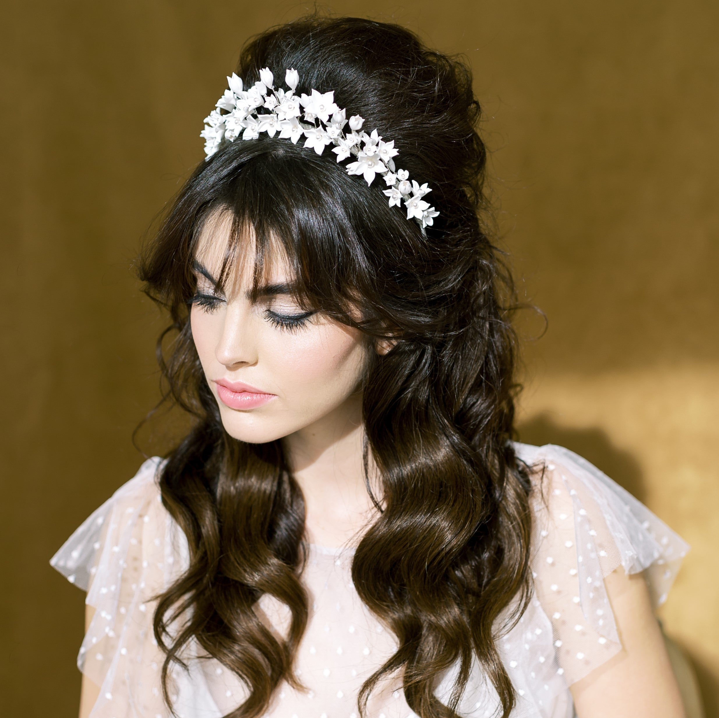 hand sculpted clay flowers in various sizes and shapes hand wired to a metal wire headband with glass pearl centres. This beautiful bridal crown is available in white or ivory flowers and in silver, gold or rose gold finishes. handmade in toronto canada by Blair Nadeau Bridal Adornments